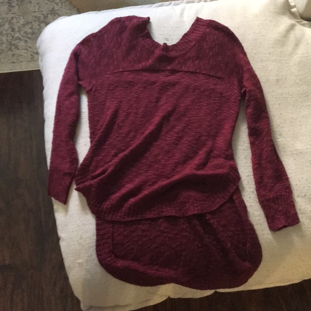 Maroon sweater. Short in the front, longer in back